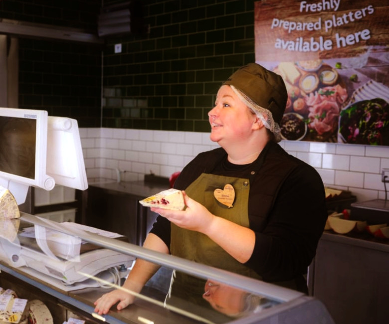 Deli colleague serving a customer in store