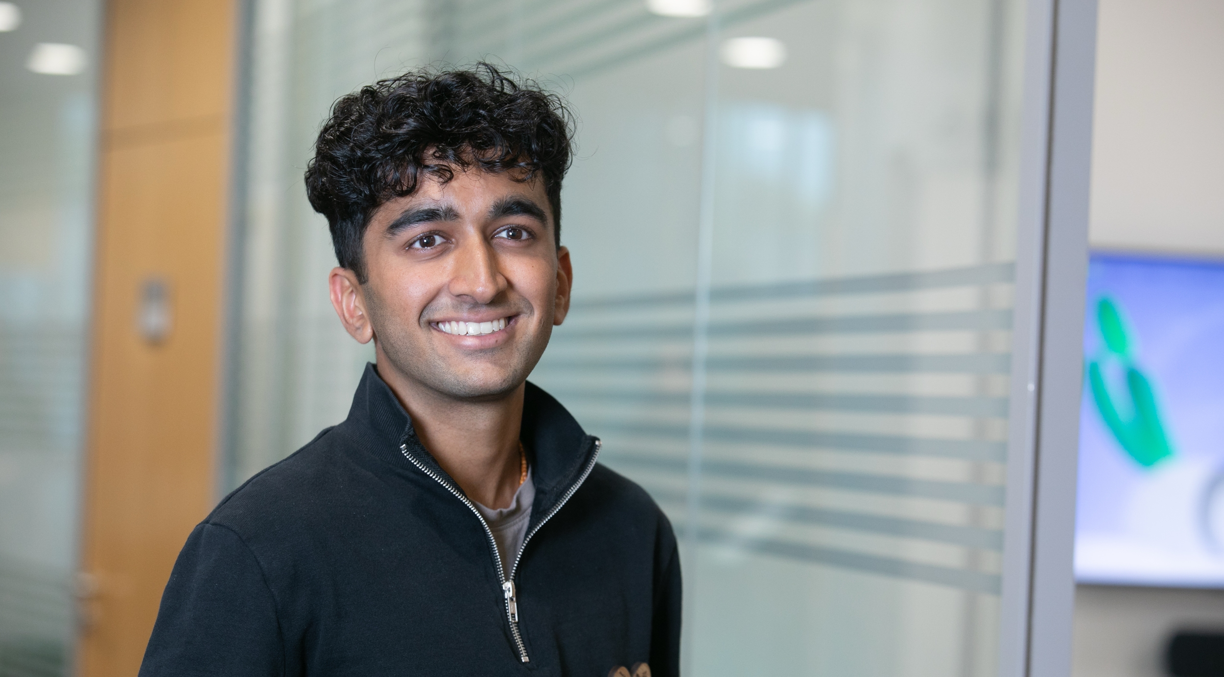 Graduate smiling in office