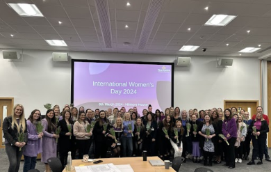Large group of female colleagues in front of Internal Womens Day 2024