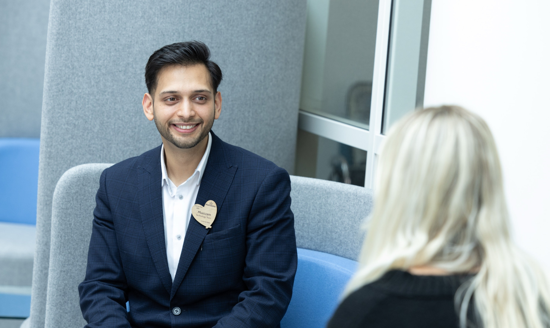 Two colleagues chatting in office