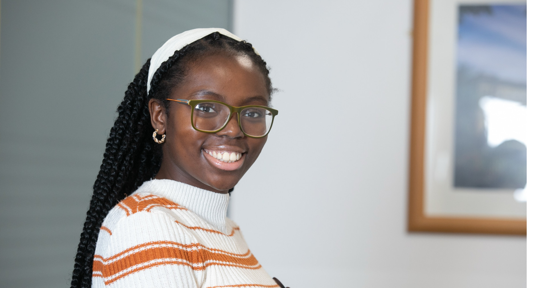 Female tech graduate in stripey jumper